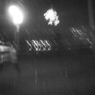 Black and white image with a bright, blurred light source.