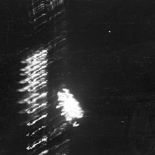 Aerial view of a nighttime fireworks display over a city.