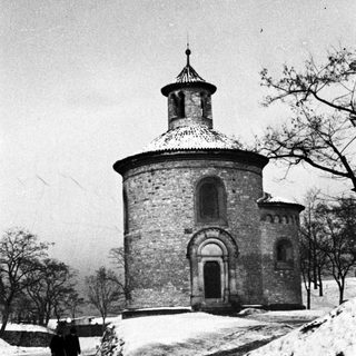 Black and white image of a round building with snow.