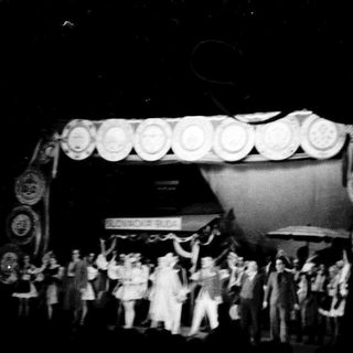 Group of people on stage with elaborate decorations.