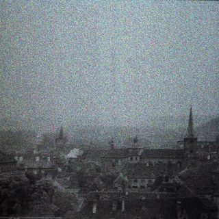 A grainy, monochrome image of a city skyline.
