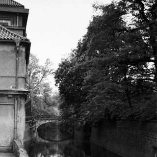 A canal viewed from a stone bridge or wall.