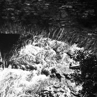 Looking up inside a stone tunnel with visible texture.