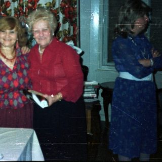 Group portrait of four people in a vintage dining room.