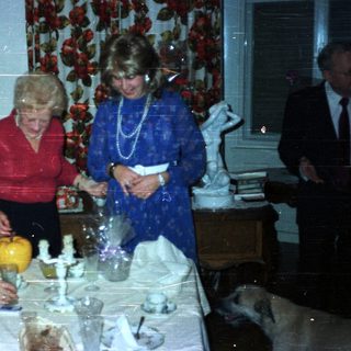 Family gathered for a formal dinner in a dining room.