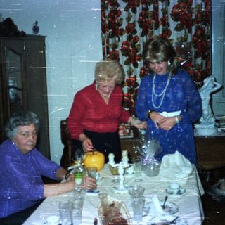 Family gathered for a formal dinner in a dining room.