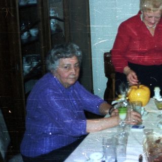 Family gathered for a formal dinner in a dining room.