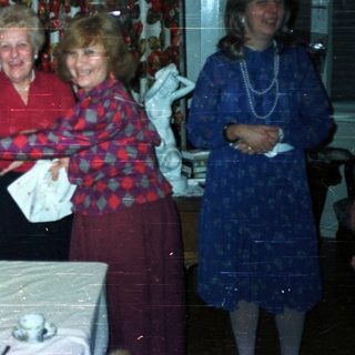 Four women gathered around a table with decorations.