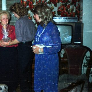 Group of people gathered in a vintage living room.