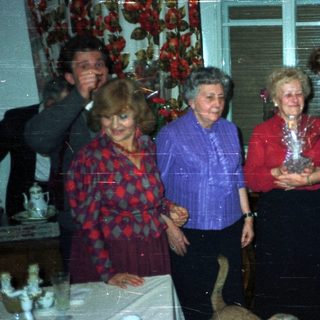 Group of people gathered in a vintage living room.