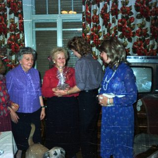 Group of people gathered in a vintage living room.