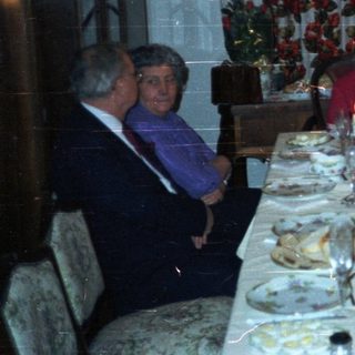 Family seated at a lavishly set dinner table.