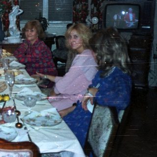 Family seated at a lavishly set dinner table.