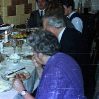 Group seated at a table enjoying a formal dinner.