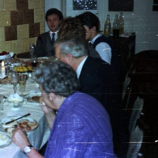 Group seated at a table enjoying a formal dinner.