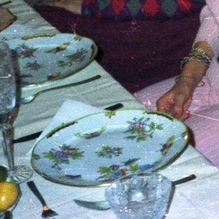 Three women seated at a table in a dimly lit room.