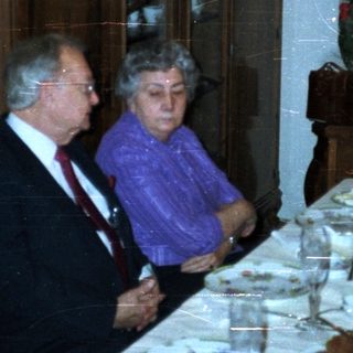 Group seated at a formal dinner table.