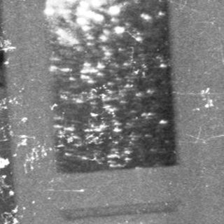 Table setting with food, dimly lit room, person visible.