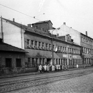 Black and white photo of a building and street scene.