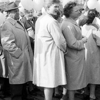 Group of people with balloons in a black and white photo.