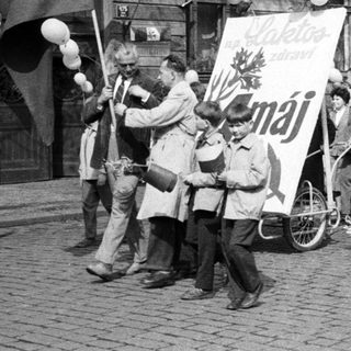 Black and white photo shows a May Day parade.