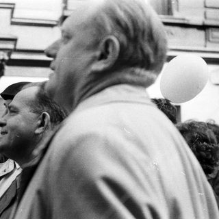 Black and white image of people with balloons.