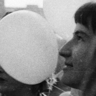 People release balloons during a gathering, likely celebratory.