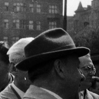 Black and white photo of people in a crowd.