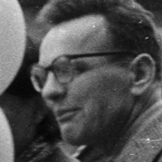 Group of men and boys with balloons, likely a public event.