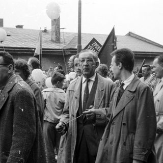 Group of men and boys with balloons, likely a public event.