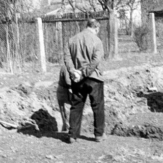 Men work on construction near residential buildings.