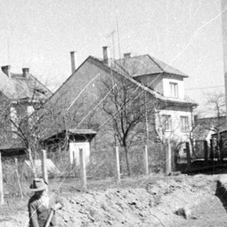 Men work on construction near residential buildings.