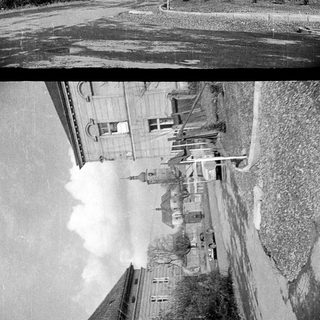 Black and white photo of a building and street scene.