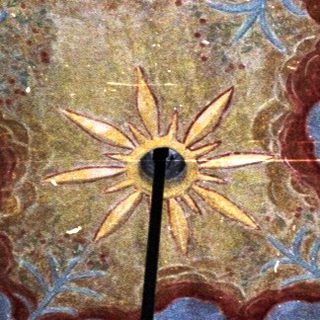 Decorated ceiling with floral patterns and a central star design.