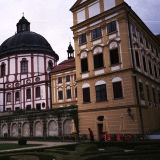 Ornate Baroque church and building complex in a garden.