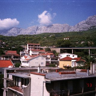 Coastal town nestled at the base of a mountain range.