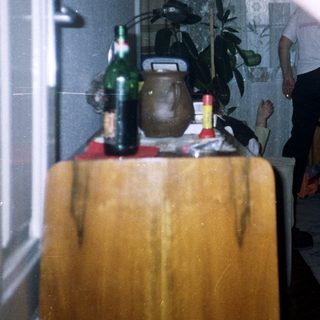 Blurred motion captures a person in a room with furniture.