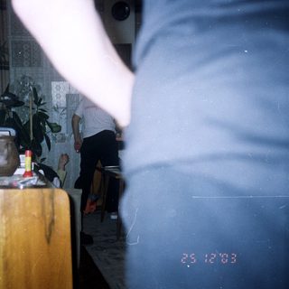 Blurred motion captures a person in a room with furniture.
