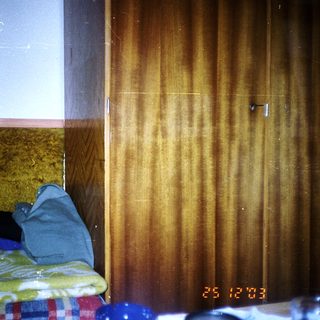 Stacked towels and a wooden door in a room.