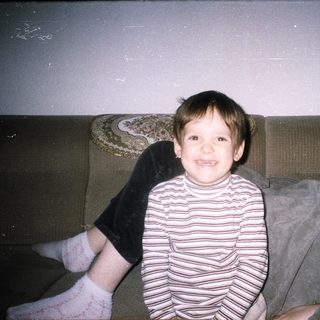 Boy and woman on a couch, captured in a photograph.