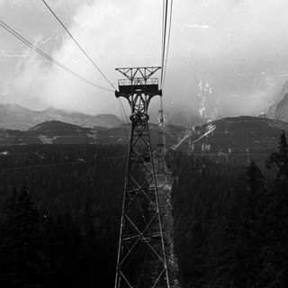 Mountain scenery with a cable car tower in the foreground.