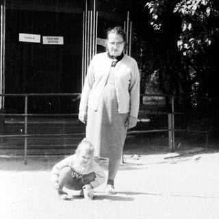 Black and white photo of a child and an older woman.