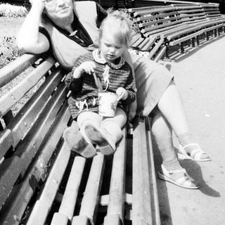 Man and child seated on a park bench.