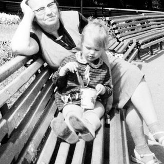 Man and child seated on a park bench.