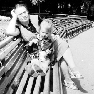 Man and child seated on a park bench.