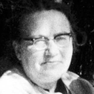 Woman and child seated on a park bench.