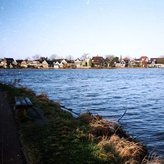 Waterfront view of houses, possibly in a coastal town.