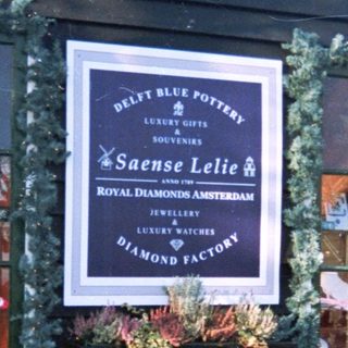 Dutch storefront displays jewelry and Delft pottery.
