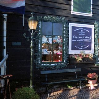 Dutch storefront displays jewelry and Delft pottery.