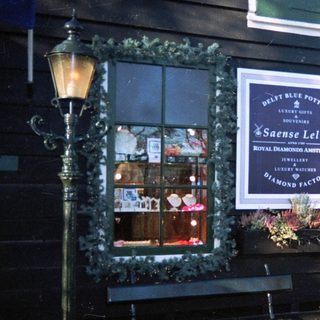Dutch storefront displays jewelry and Delft pottery.